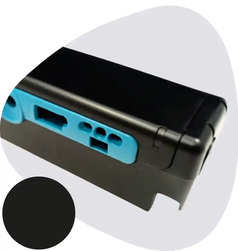Close-up of a black printer cartridge with a blue latch and multiple openings/ports.